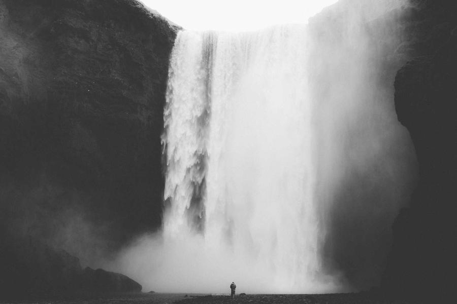 A waterfall falling into a dark rock face